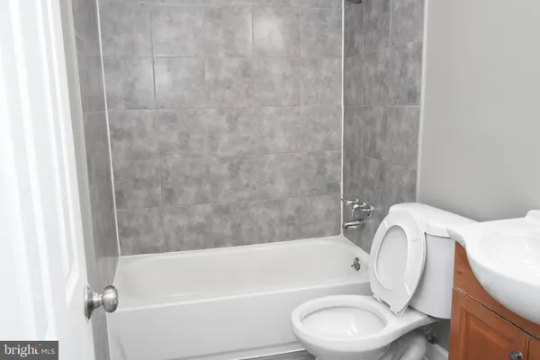 a bathroom with a toilet and a bathtub