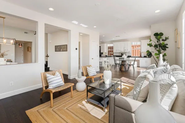 a living room with patio furniture and a potted plant