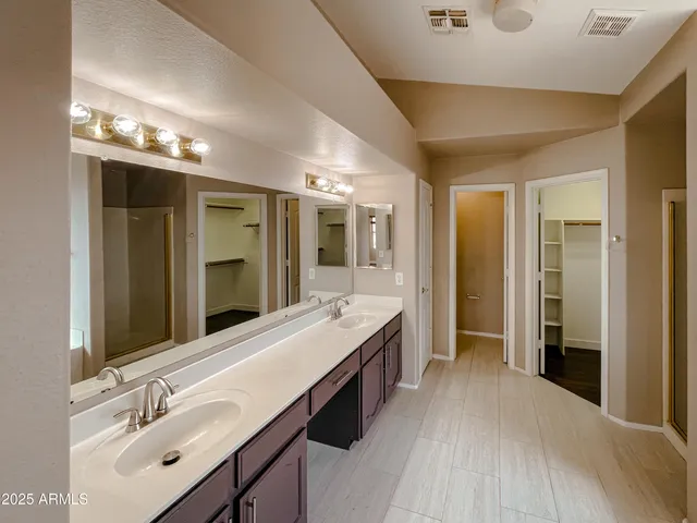 a bathroom with a double vanity sink and mirror