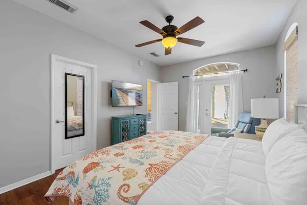 a bedroom with a bed and a chandelier