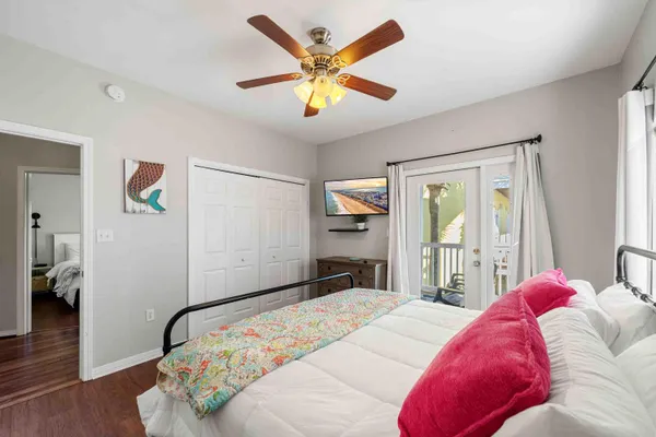 a bedroom with a large bed and a chandelier