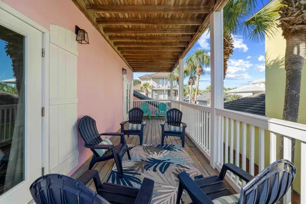 a view of a porch with furniture and a yard