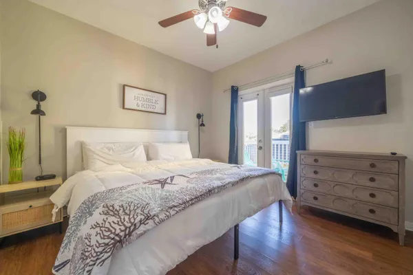 a bedroom with a bed and a flat screen tv