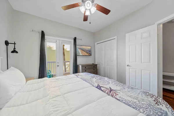 a bedroom with a large bed and a chandelier