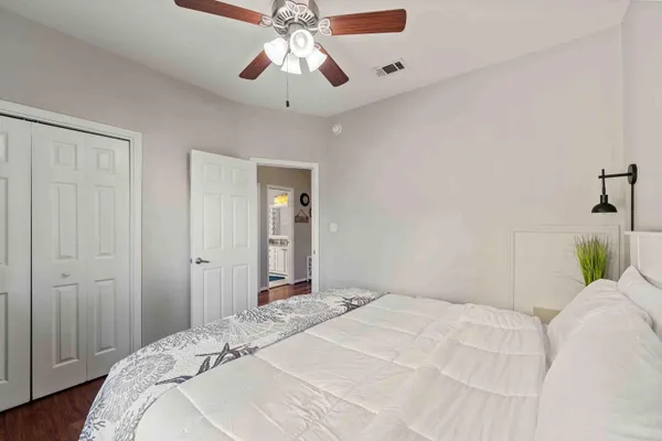 a bedroom with a large bed and a chandelier
