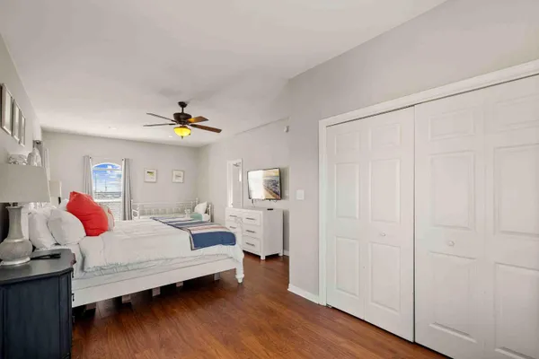 a bedroom with a bed and wooden floor