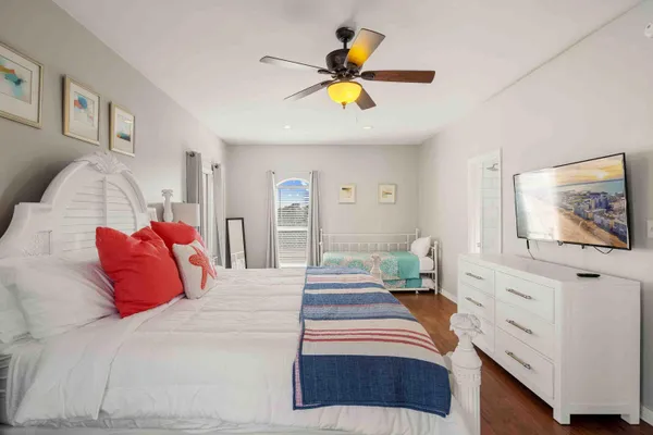 a bedroom with a large bed and a chandelier