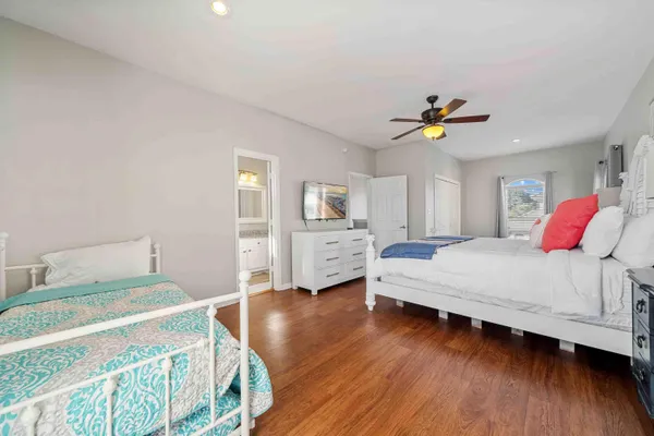 a bedroom with a bed and a wooden floor