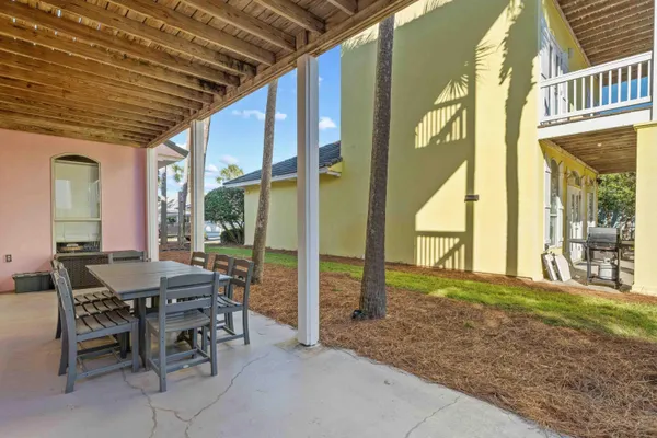 a view of an outdoor dining space with furniture and garden view