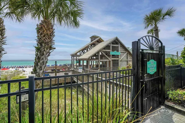 a view of a house with large windows and a palm tree