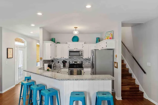 a kitchen with cabinets and refrigerator
