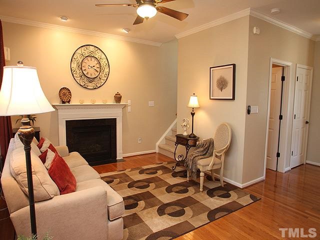 1806 Patterson Grove Road Apex, NC 27502 - Photo 7 of 25 Our family room is next to see on the right side. It features a gas fireplace with granite surround and a wall of windows facing the screen porch. This home has crown molding throughout the entire first floor, one of the many upgrades you'll enjoy here.