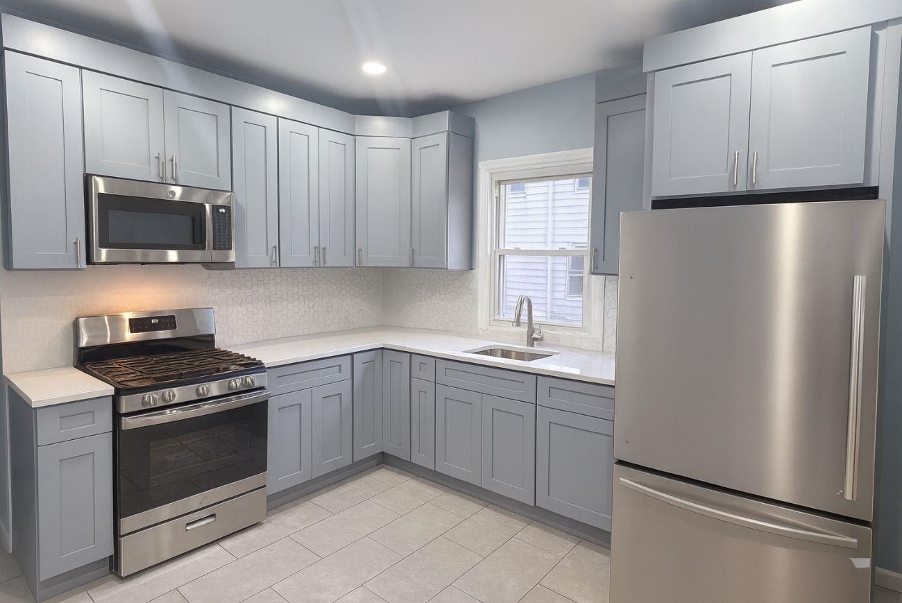 a kitchen with stainless steel appliances a refrigerator stove and microwave
