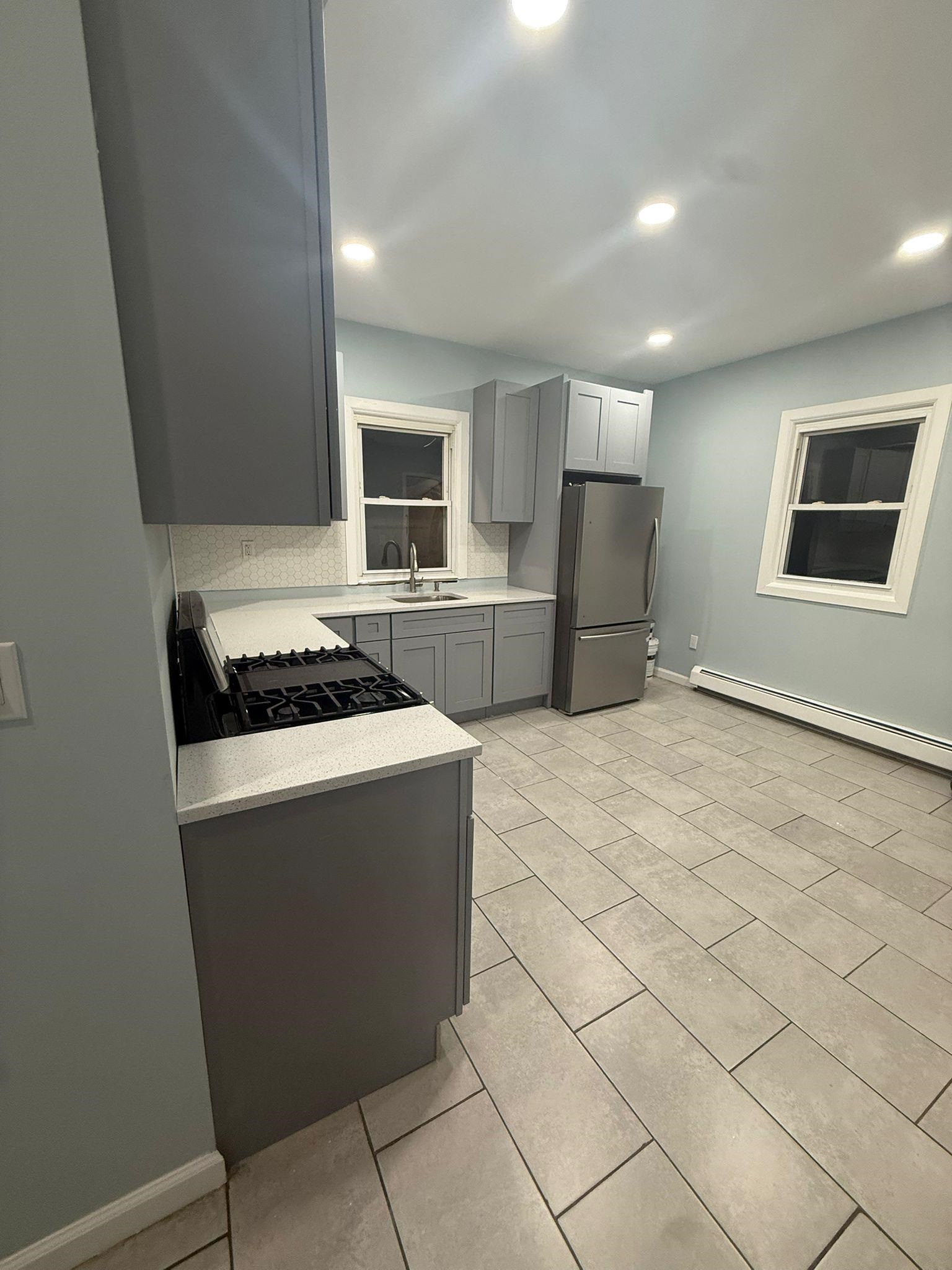 100 Rosa Parks Boulevard, Unit 1 Paterson, NJ 07501 - Photo 2 of 14 a kitchen with stainless steel appliances a refrigerator stove and microwave