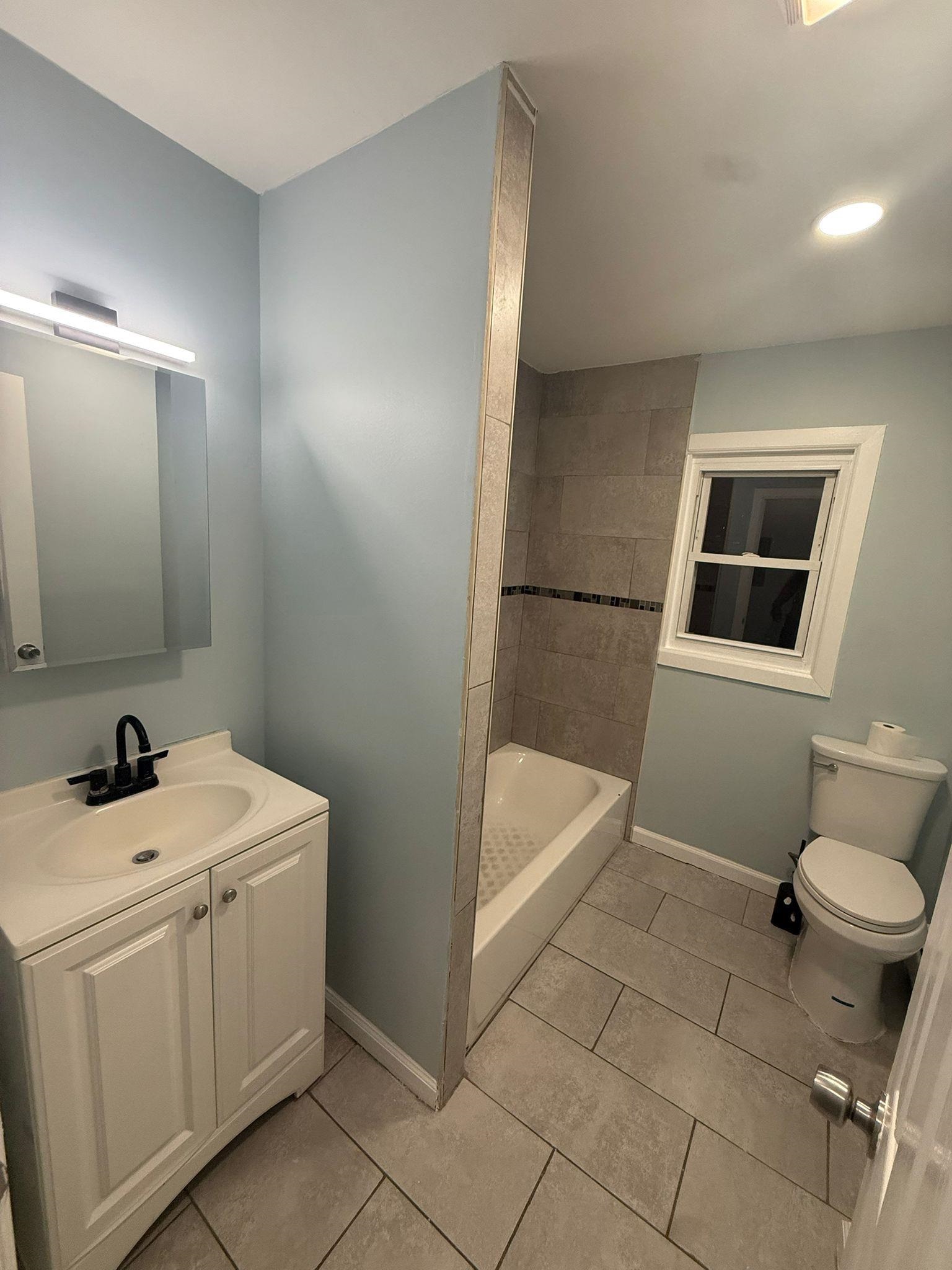 100 Rosa Parks Boulevard, Unit 1 Paterson, NJ 07501 - Photo 6 of 14 a bathroom with a sink toilet and tub