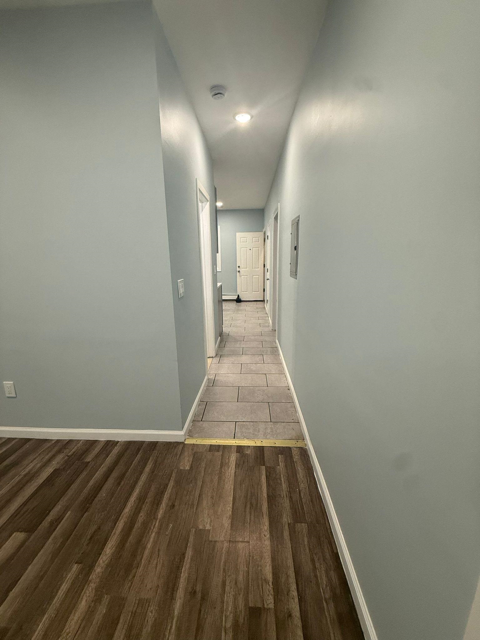 100 Rosa Parks Boulevard, Unit 1 Paterson, NJ 07501 - Photo 7 of 14 a view of a hallway with wooden floor