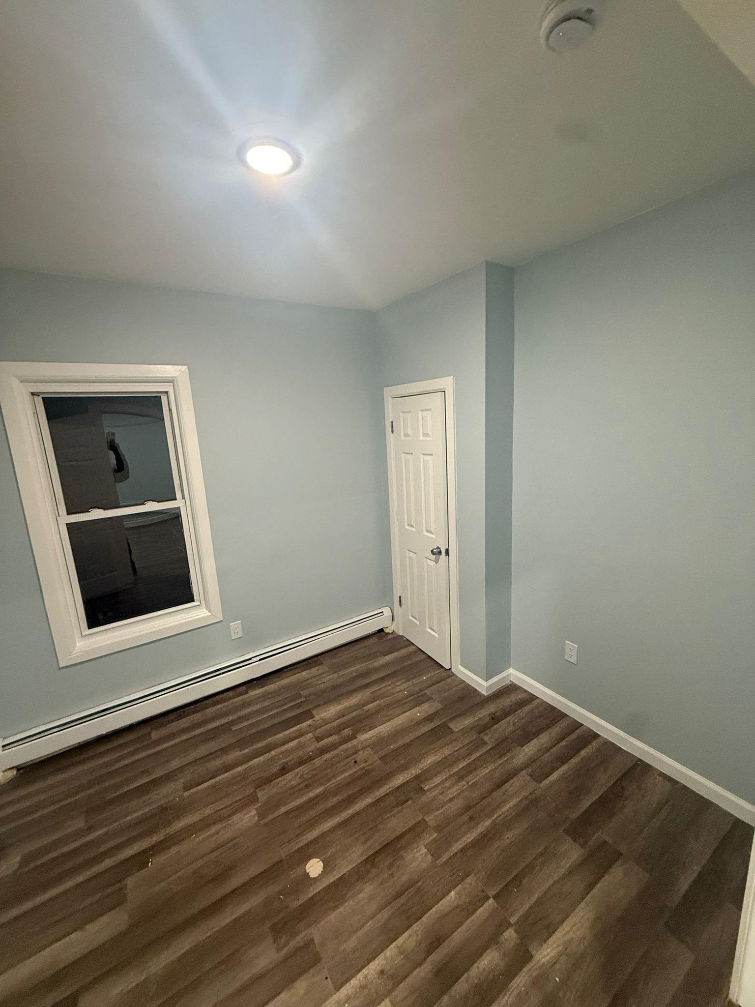 100 Rosa Parks Boulevard, Unit 1 Paterson, NJ 07501 - Photo 8 of 14 a view of an empty room with wooden floor and a window