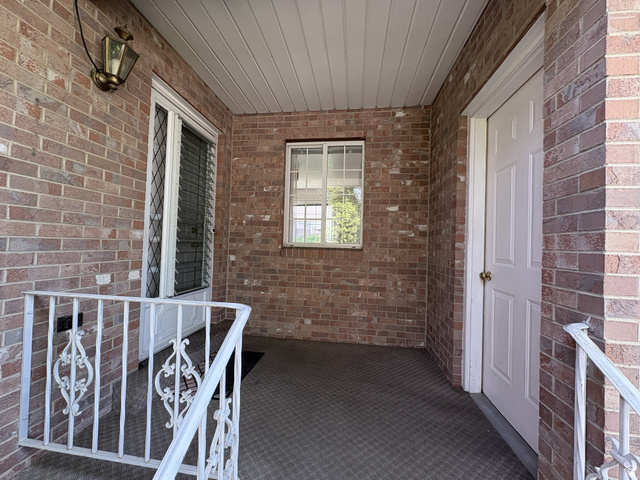 486 West 120 North Orem, UT 84057 - Photo 3 of 30 Covered front porch featuring a brick facade and white railing