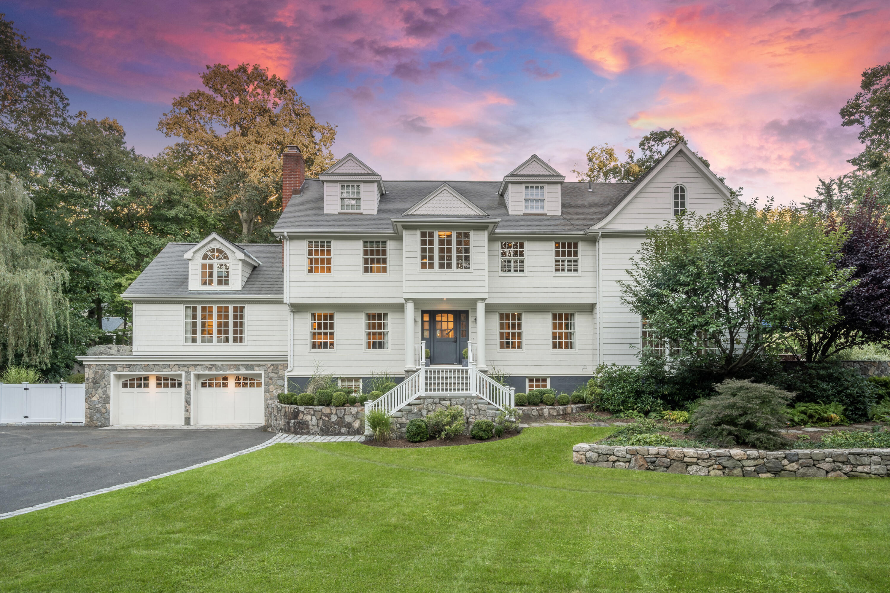a front view of a house with a garden