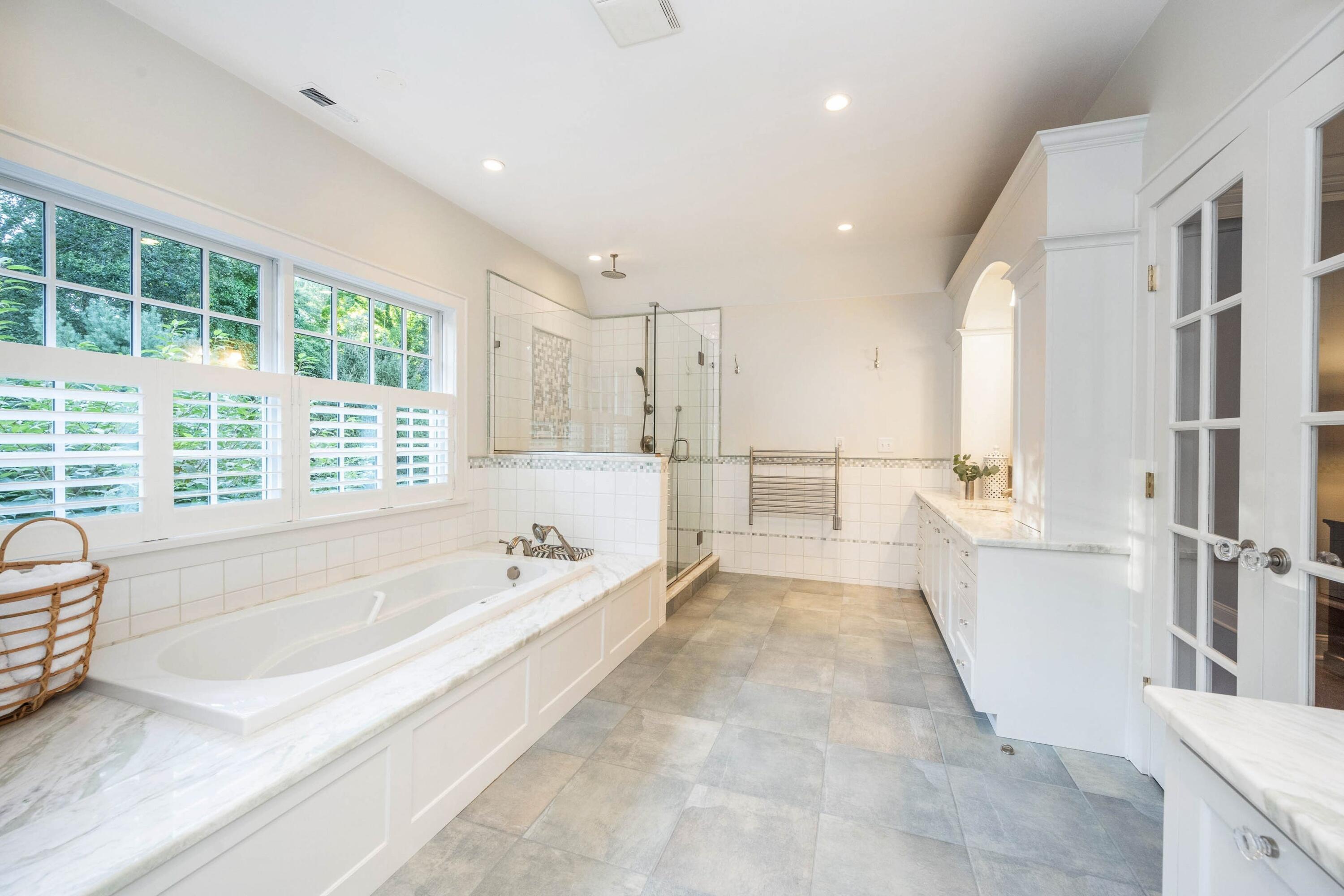 41 Delafield Island Road Darien, CT 06820 - Photo 15 of 30 a spacious bathroom with a tub double vanity window and a bathtub