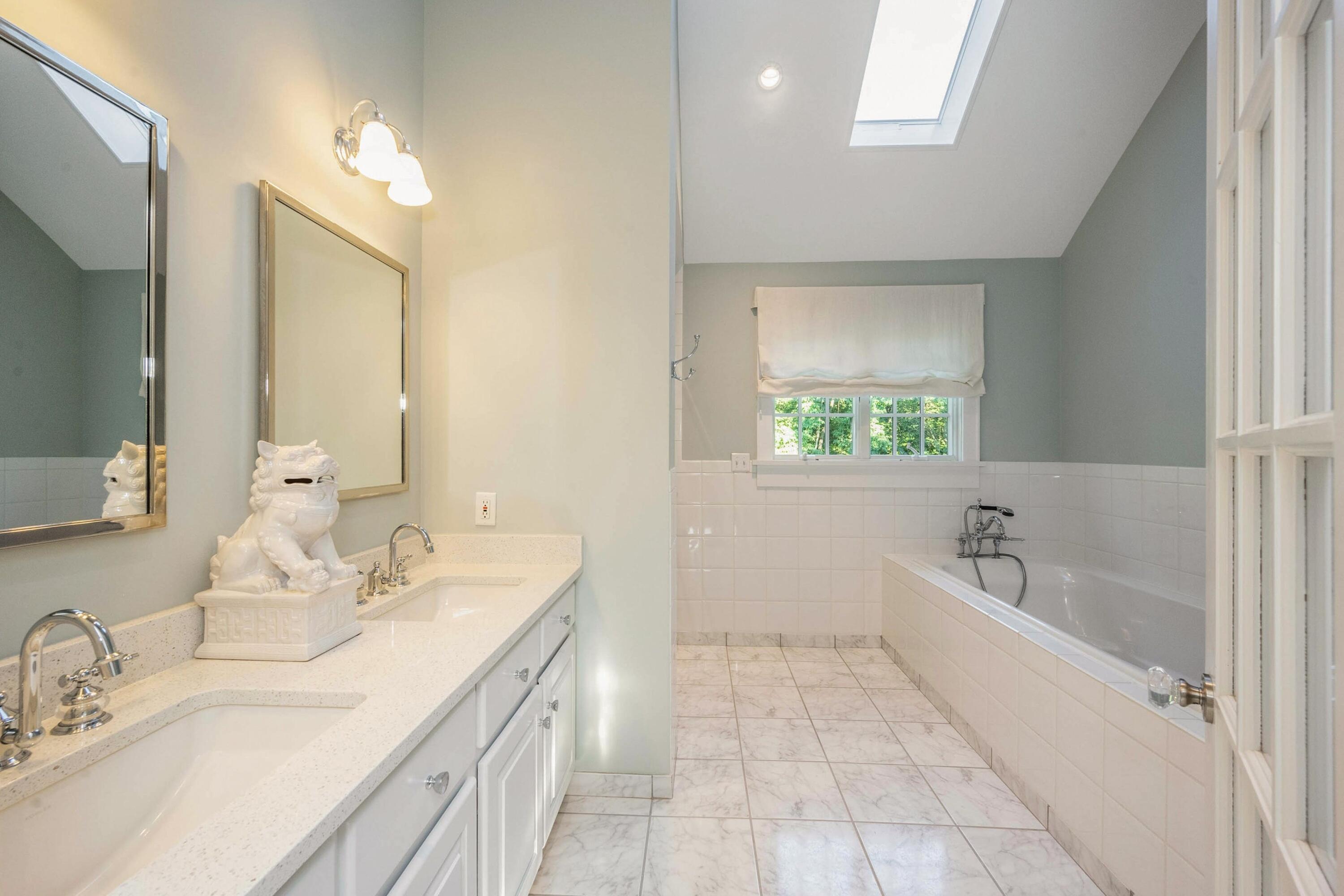 41 Delafield Island Road Darien, CT 06820 - Photo 18 of 30 a bathroom with a granite countertop sink a large mirror a bathtub and window