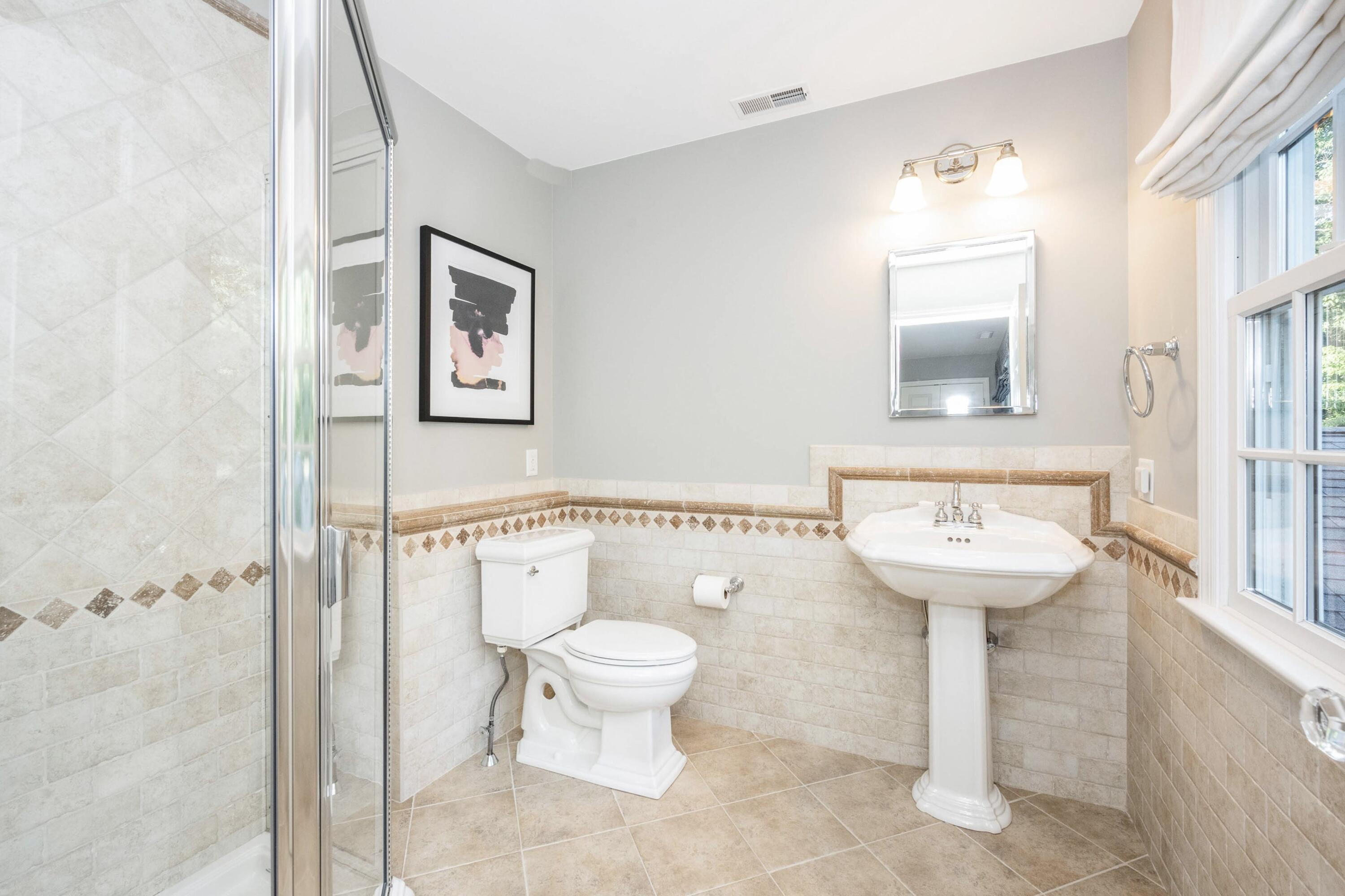 41 Delafield Island Road Darien, CT 06820 - Photo 20 of 30 a bathroom with a toilet sink and mirror