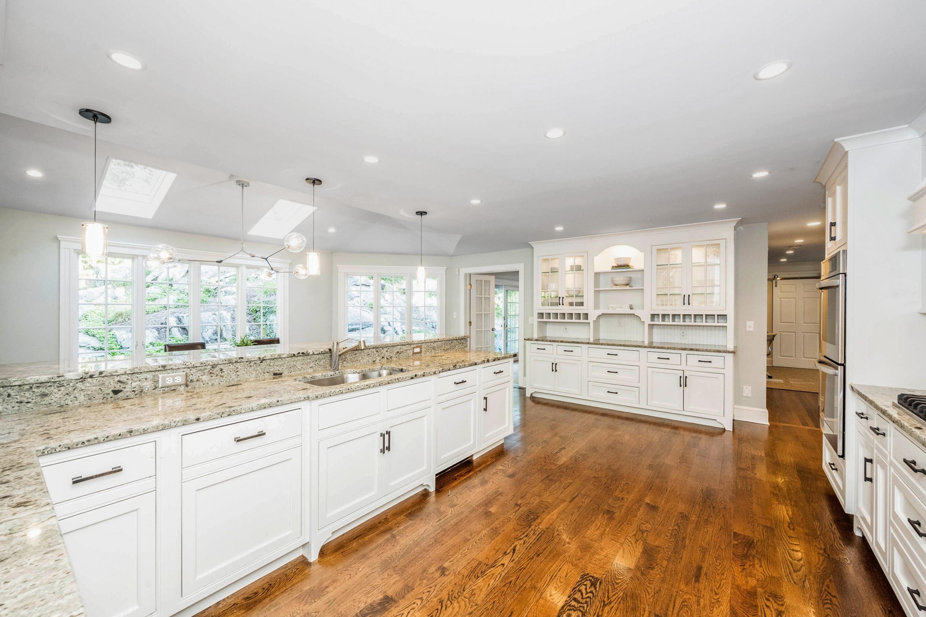 41 Delafield Island Road Darien, CT 06820 - Photo 6 of 30 a large kitchen with stainless steel appliances kitchen island granite countertop a large window and white cabinets