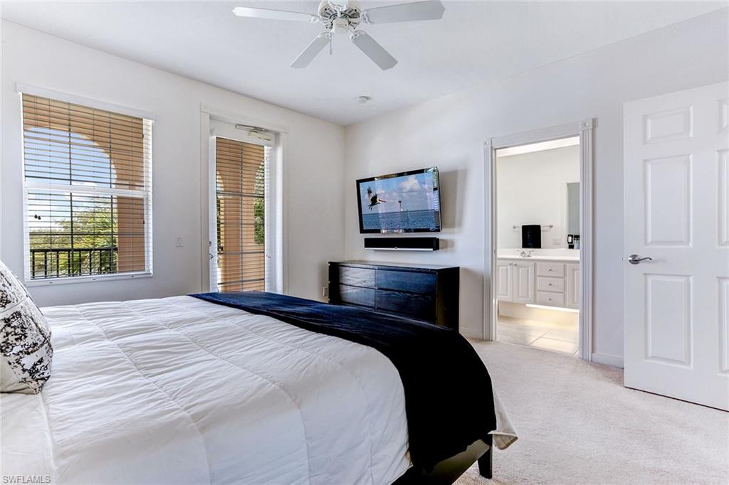 8334 Rimini Way Naples, FL 34114 - Photo 14 of 34 a bedroom with a bed and a flat tv screen on dresser