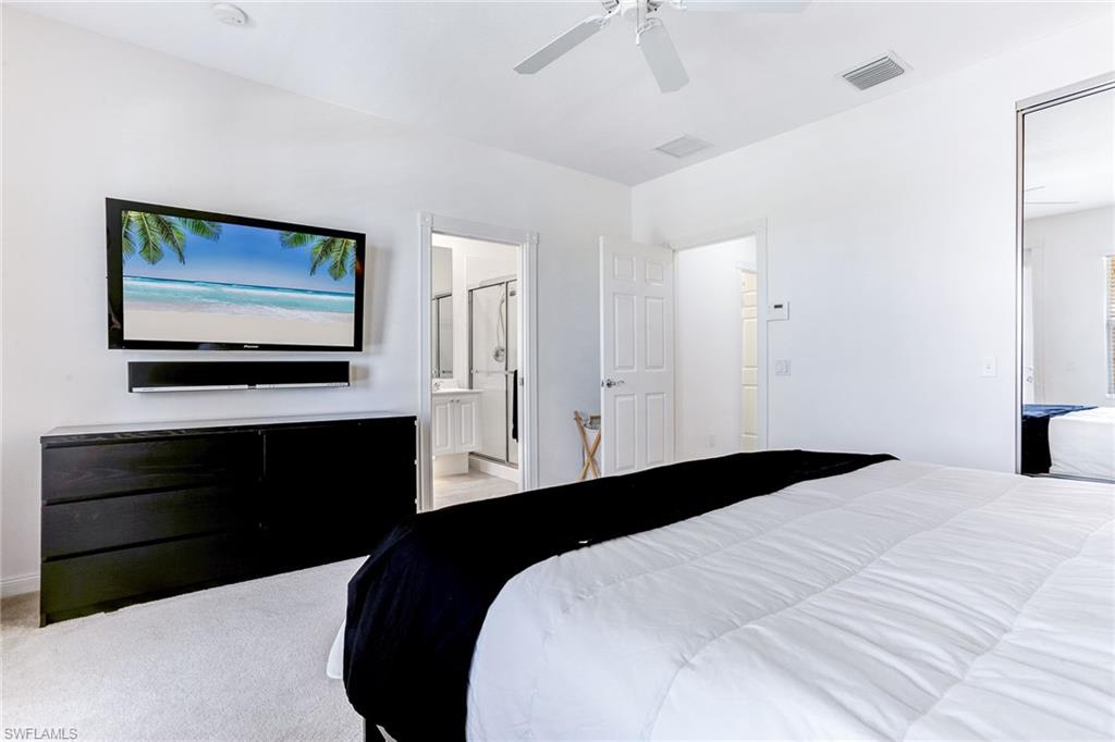 8334 Rimini Way Naples, FL 34114 - Photo 15 of 34 a bedroom with a bed and a painting on the wall