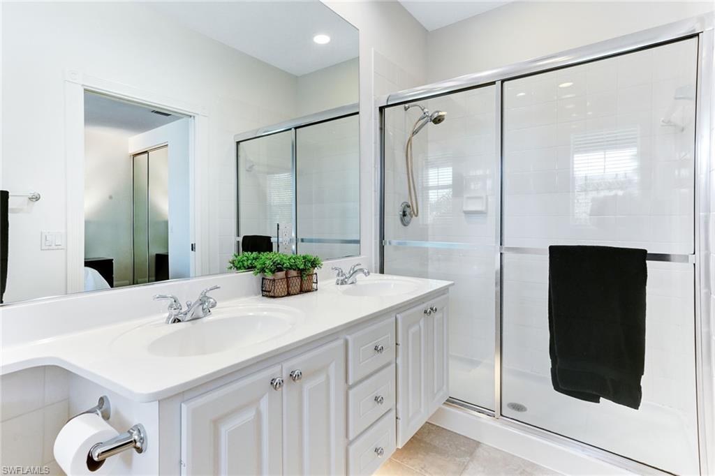 8334 Rimini Way Naples, FL 34114 - Photo 17 of 34 a bathroom with a double vanity sink and mirror