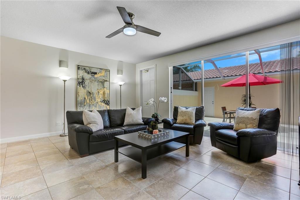 8334 Rimini Way Naples, FL 34114 - Photo 2 of 34 a living room with furniture and a large window