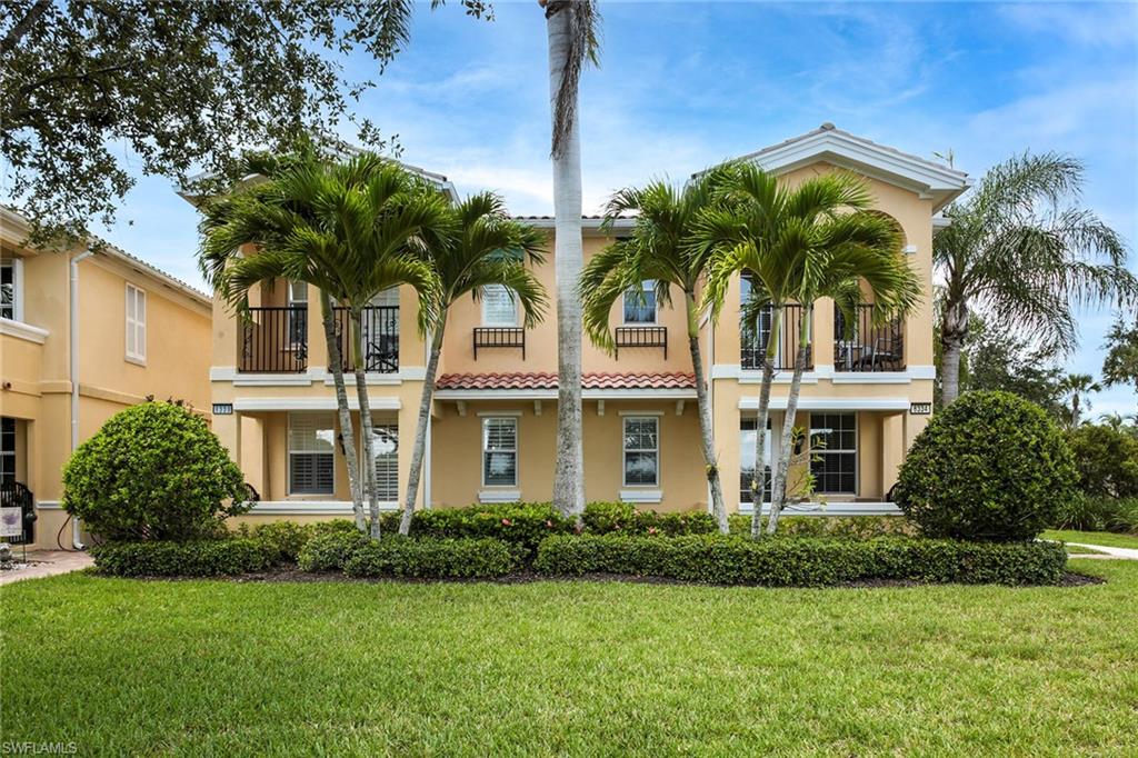 8334 Rimini Way Naples, FL 34114 - Photo 25 of 34 a front view of multi story residential apartment building with yard and green space