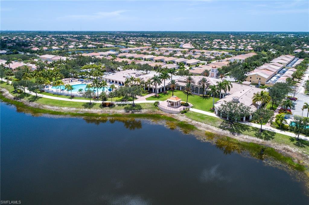 8334 Rimini Way Naples, FL 34114 - Photo 29 of 34 an aerial view of a house with a garden and lake view