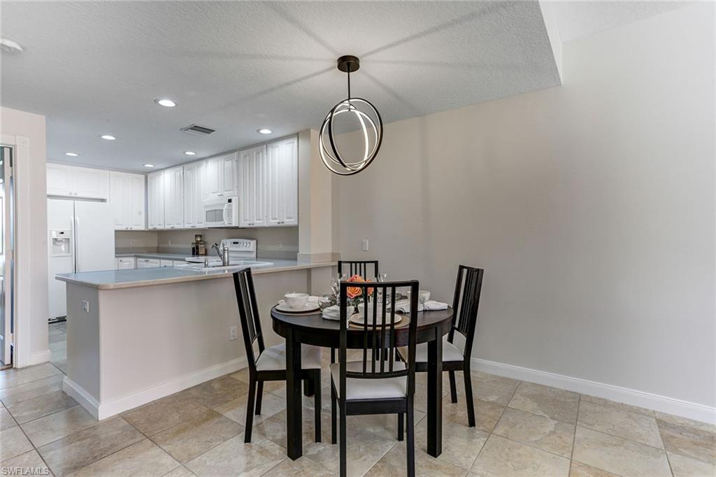 8334 Rimini Way Naples, FL 34114 - Photo 7 of 34 a kitchen with a table and chairs in it