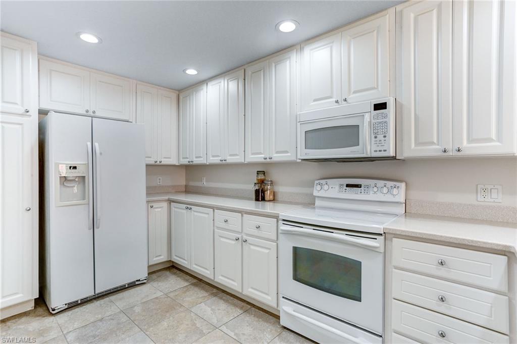 8334 Rimini Way Naples, FL 34114 - Photo 9 of 34 a kitchen with cabinets appliances and a sink