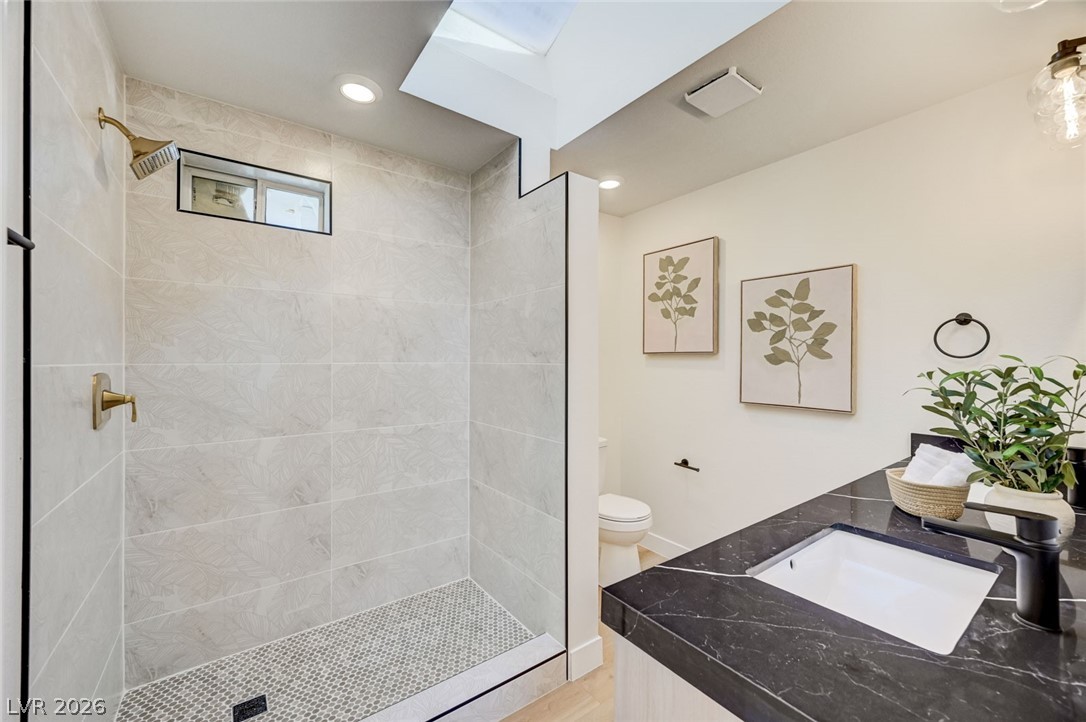 732 8th Street Boulder City, NV 89005 - Photo 11 of 15 Bathroom with vanity, tiled shower, and recessed lighting