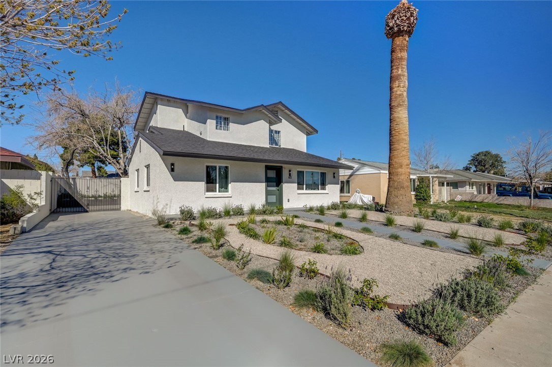 732 8th Street Boulder City, NV 89005 - Photo 2 of 15 View of front of house with driveway, a gate, and stucco siding
