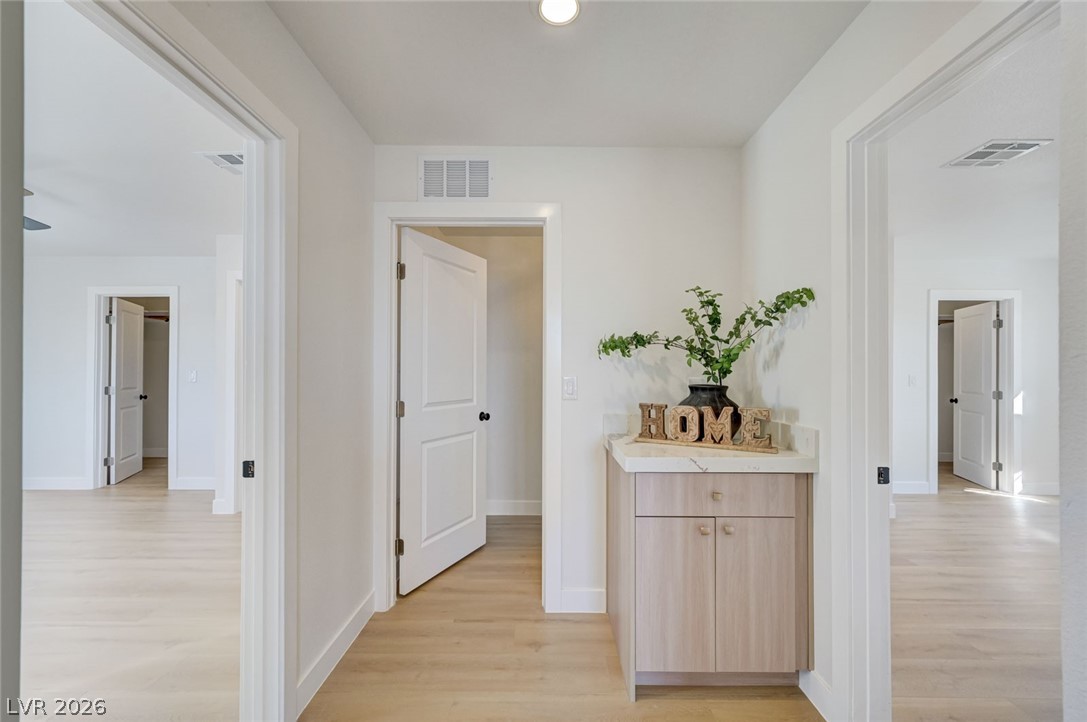 732 8th Street Boulder City, NV 89005 - Photo 9 of 15 Corridor featuring light wood finished floors and baseboards