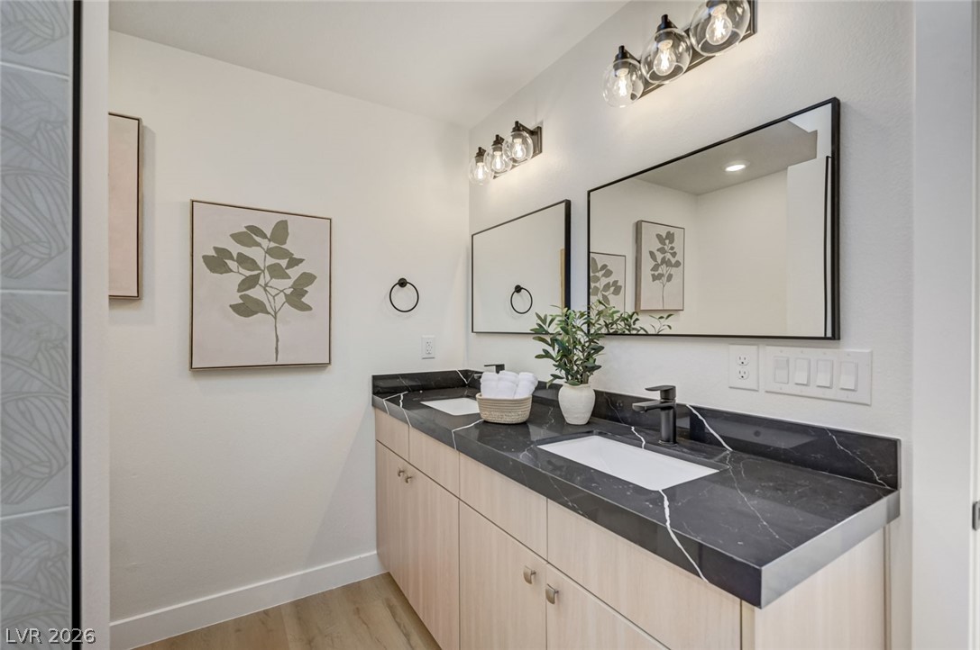732 8th Street Boulder City, NV 89005 - Photo 10 of 15 Bathroom with double vanity and light wood-style flooring