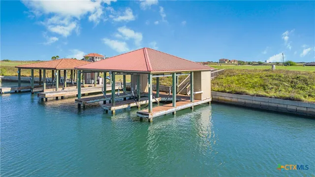 a view of a patio with lawn chairs under an umbrella