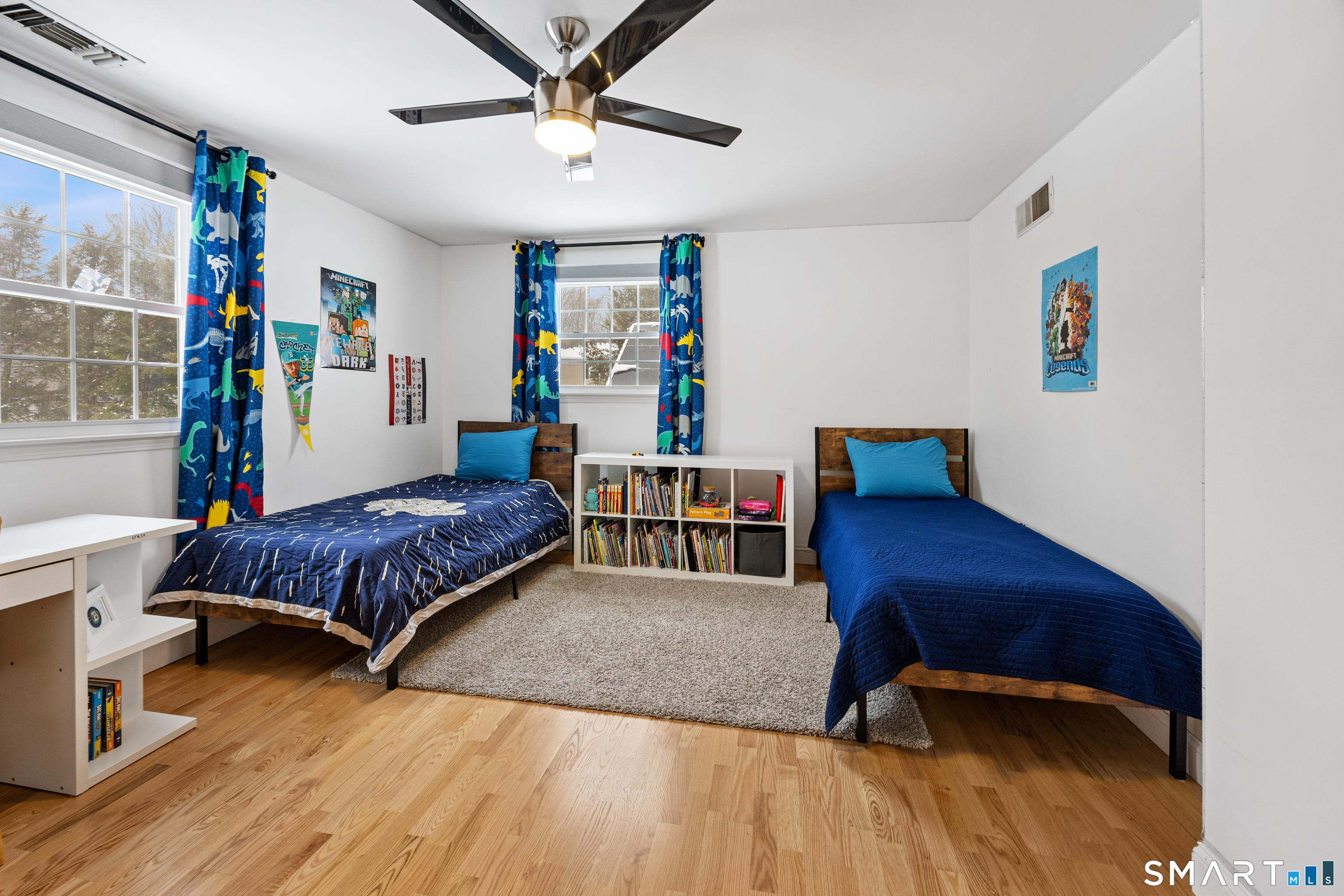 5 Crosswood Road Farmington, CT 06032 - Photo 26 of 40 a bedroom with a bed and a bookshelf