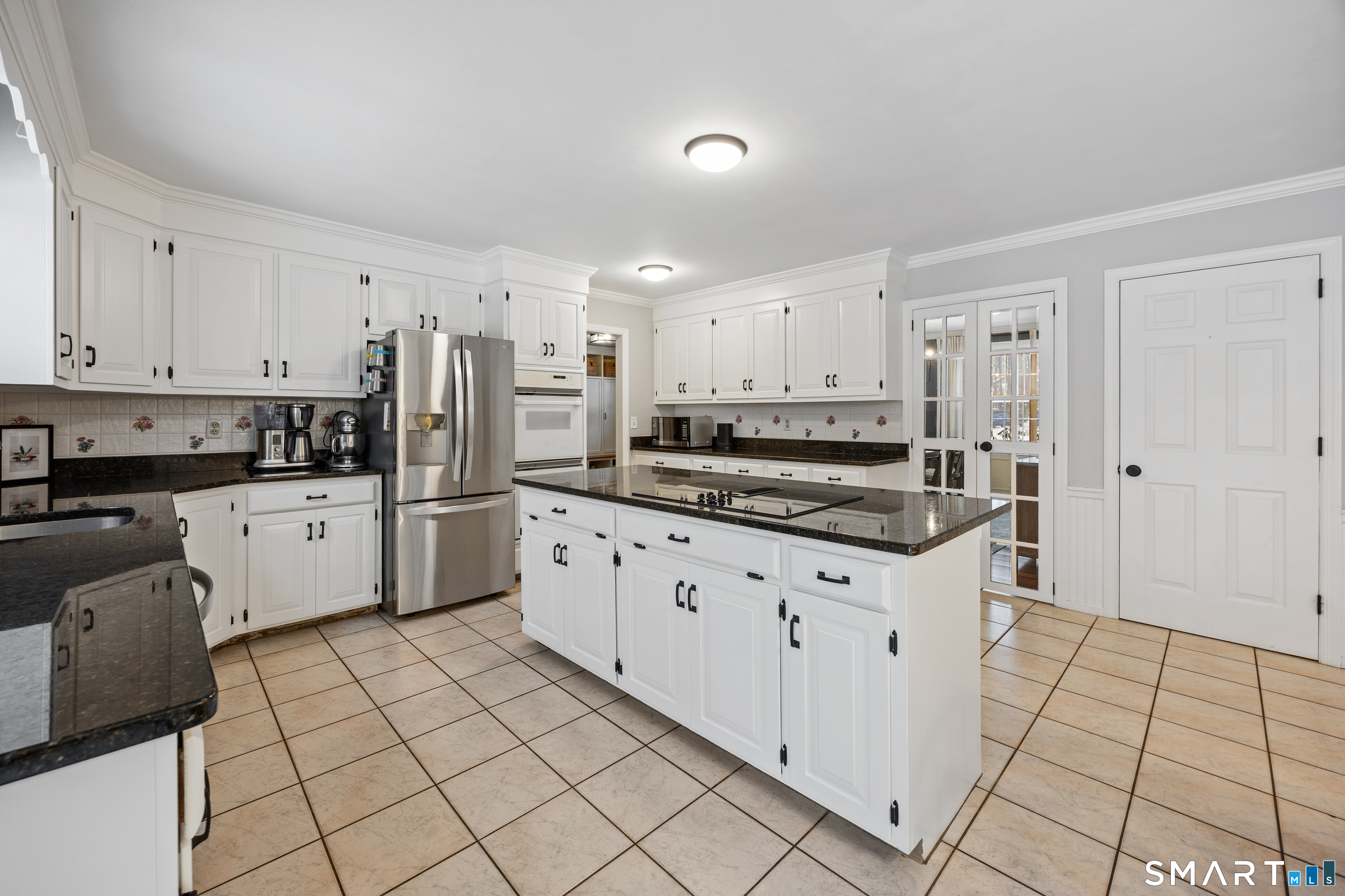 5 Crosswood Road Farmington, CT 06032 - Photo 8 of 40 a kitchen with granite countertop a refrigerator oven a sink and white cabinets