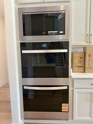 a stove top oven sitting inside of a kitchen