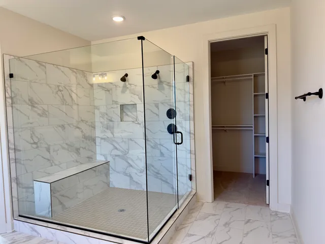 a bathroom with a glass shower door