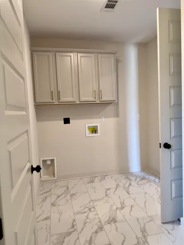 a view of storage and utility room with a window