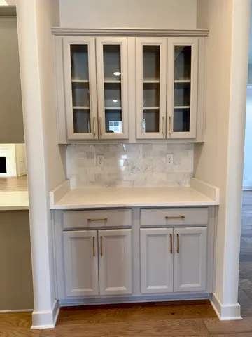 a view of granite countertop white cabinets and a sink