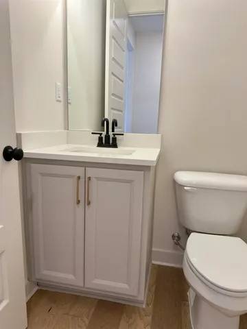 a bathroom with a toilet a sink and a mirror