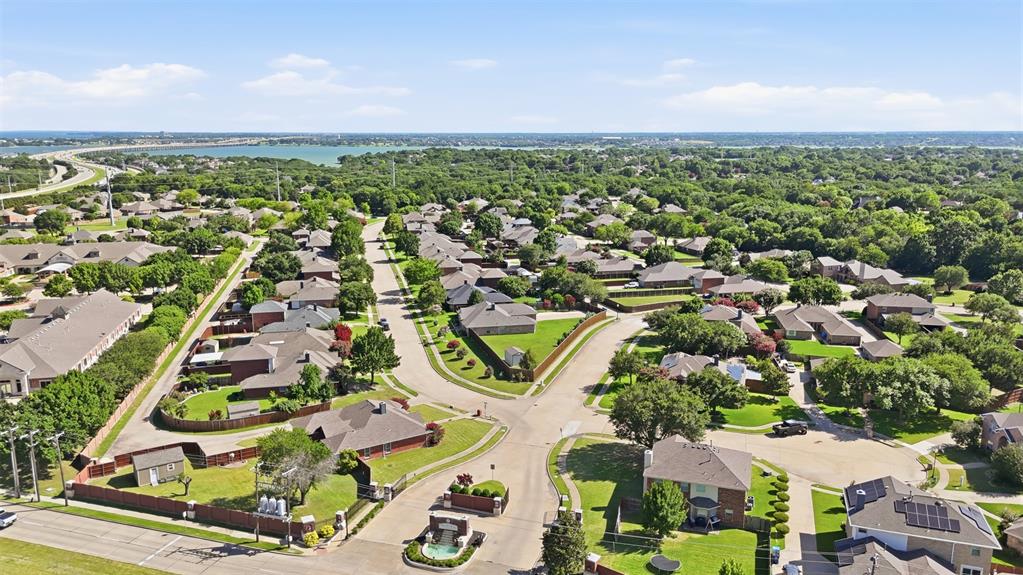 4218 Glistening Spring Rowlett, TX 75088 - Photo 37 of 39 Aerial perspective of a residential neighborhood featuring established homes with mature trees and green landscaping