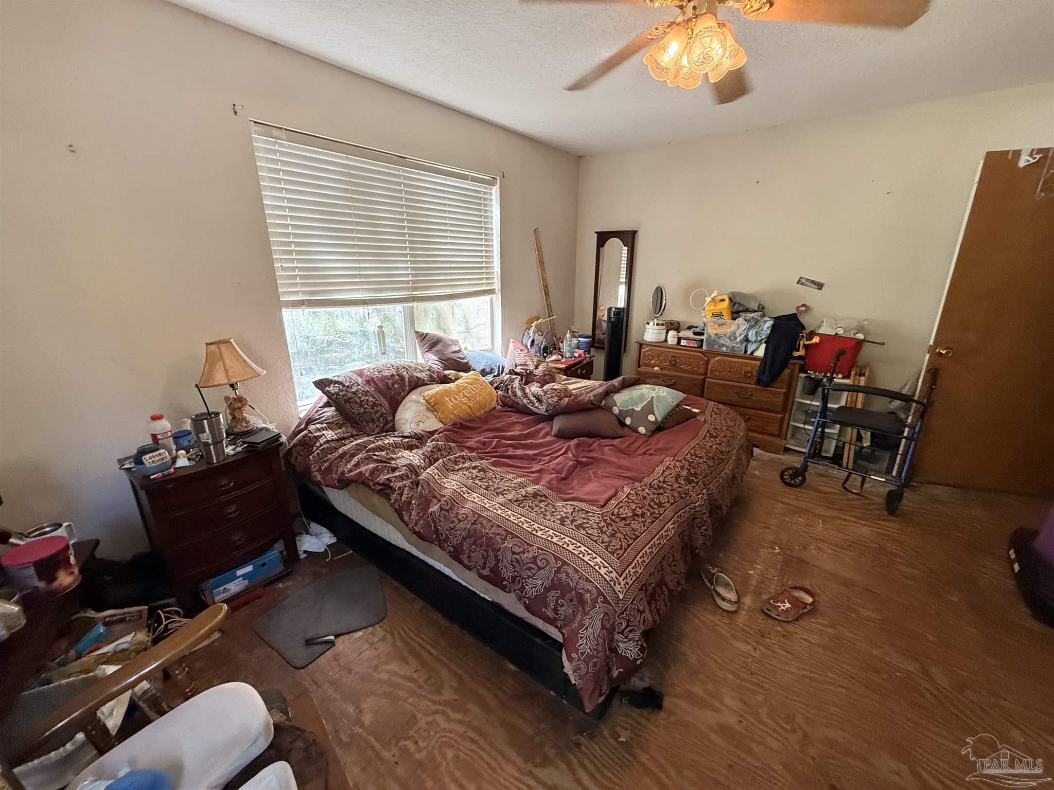9543 Quiet Creek Road Milton, FL 32570 - Photo 12 of 45 a bedroom with a bed and wooden floor