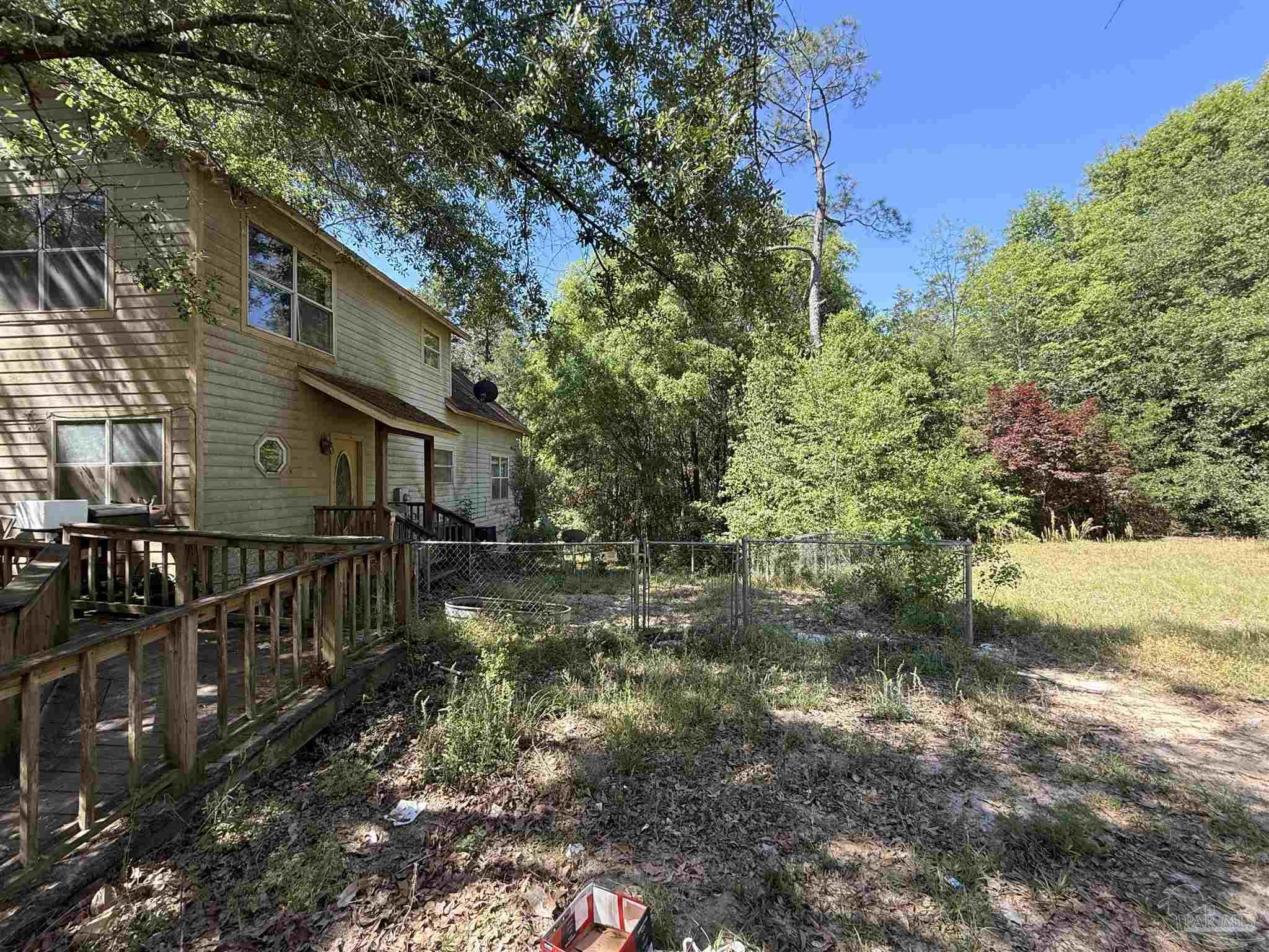 9543 Quiet Creek Road Milton, FL 32570 - Photo 3 of 45 a view of a house with a yard